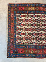 One end view of antique Persian rug.