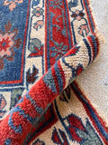 Traditional border design showing a simple floral chain pattern on an antique Caucasian rug.