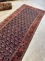 Technicolor Persian rug with intricate floral and geometric details.