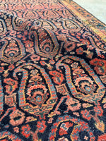 Antique wool runner with rich design elements.