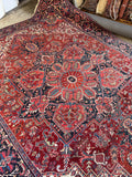 Large antique wool rug. Persian Heriz carpet with vivid vegetable dyes, geometric motifs, and an uncommon medallion border design.
