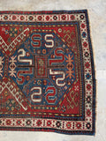 One end of Kazak rug with traditional tribal symbols.