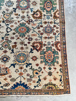 Unique vintage rug with rich blue, green, and orange hues.
