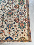 Unique vintage rug with rich blue, green, and orange hues.