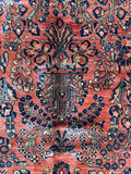 Large living room Persian rug with salmon coral field and botanical pattern.