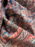 Vintage Persian rug with aged dyes and a low pile.