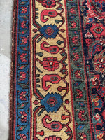 Persian Bidjar rug featuring linked florals and paisley motifs in the border.