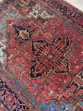 Hand knotted Heriz rug 7’ x 9’9 in vegetable dyed wool with rich color shifts and durable weave.