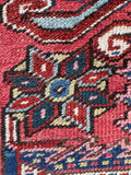 Persian Heriz rug hand knotted wool texture close up.