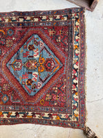 One end of rug showing medallion and abstract geometric motifs.