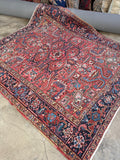 Heriz rug watermelon red ground with blue accents.