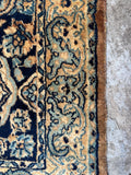 Border pattern detail of vintage Kerman rug with ivory and blue accents.