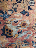 Antique Kerman rug with intricate curving vine patterns.