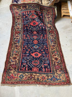 Antique Persian Kurdish rug with navy field and camel border..