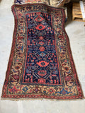 Antique Persian Kurdish rug with navy field and camel border..