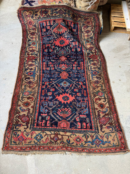 Antique Persian Kurdish rug with navy field and camel border..