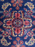 Early 1900s Persian Lilihan rug with decorative floral sprays and soft wear.