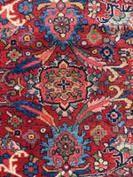 Detailed view of floral motifs against red background.