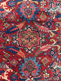 Detailed view of floral motifs against red background.