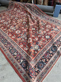 Antique 1920s Persian Mahal rug with allover floral design and rich red field.