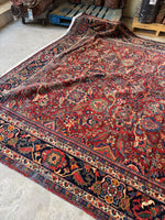 Side view of antique Mahal rug with floral design.
