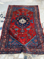 Full view of antique 1920s Persian Malayer rug with bold red and navy tones.