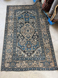 Persian Malayer rug with geometric medallion and floral accents.