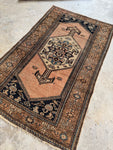 Handwoven Persian rug from the 1920s featuring whimsical fish and animal motifs.