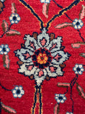 Detail of floral motif in a hand-knotted Persian Tabriz rug.