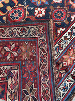 Underside of rug showing handwoven wool foundation and knotting