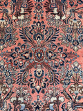 Antique Persian Rug with floral sprays, coral ground, navy accents, and thick healthy wool pile for everyday living.