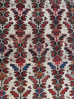 Persian rug with flower and petal motifs in linear layout.