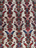 Persian rug with flower and petal motifs in linear layout.