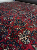 Detailed view of sage green and chestnut wool in rug design.
