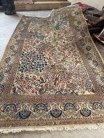 Persian rug with ivory field and bird design, crafted in the 1940s.