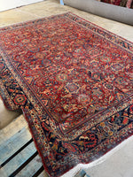 Persian rug with ornate pattern and aged texture.