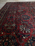 Decorative Persian rug with ruby and burgundy.