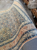 Hand knotted Persian rug full view displaying intricate water garden design and detailed floral chain border.