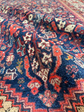Low pile Persian rug with vegetable-dyed wool construction.