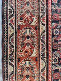 Vintage Persian rug with unique pattern on rust red ground in main border and ivory vine and blossom design in the narrow border.