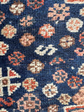 S-hook motifs woven into the field as protective symbols.