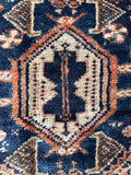 Detailed view of medallion with layered tribal elements.