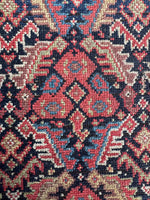 1920s Persian rug with intricate repeating motifs.