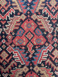 1920s Persian rug with intricate repeating motifs.