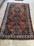 Worn in Persian Shiraz rug featuring peacock motifs and vegetable dyed wool.