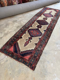 Skinny antique hallway runner with bold tribal design.
