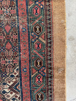 Antique hallway runner featuring colorful chain motif border.