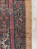 Antique hallway runner featuring colorful chain motif border.