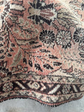 Handwoven antique Persian runner with paisley and floral borders.