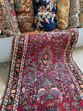 Antique Persian runner with floral chain borders and rich red ground.
